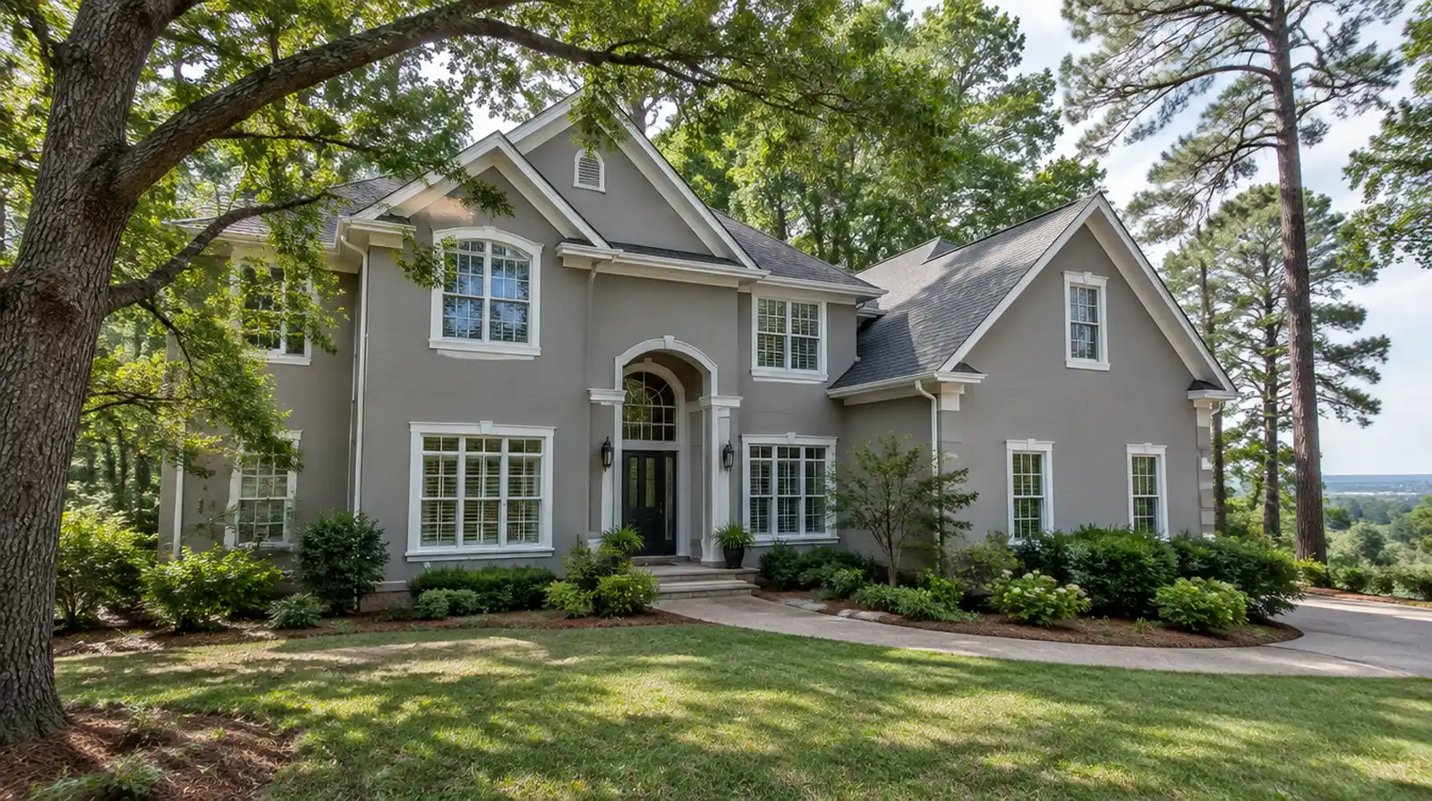 Two-story house with freshly resurfaced warm gray synthetic stucco and white trim